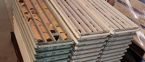 Stacks of plastic core trays with irregularly shaped core samples